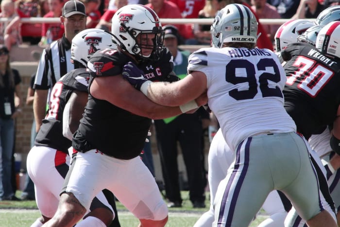 Oct 23, 2021; Lubbock, Texas, USA; Texas Tech Red Raiders offensive center Dawson Deaton (73) blocks Kansas State Wildcats defensive tackle Eli Huggins (92) in the second half at Jones AT&T Stadium. Mandatory Credit: Michael C. Johnson-USA TODAY Sports